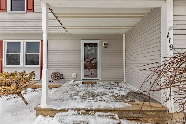 view of snow covered property entrance