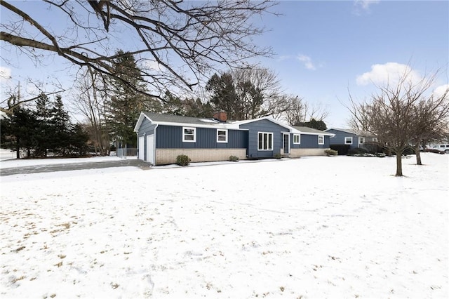 view of snow covered rear of property