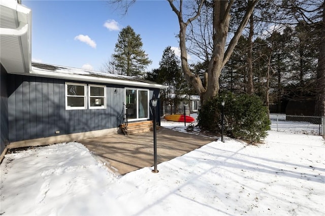 snow covered deck featuring a patio area