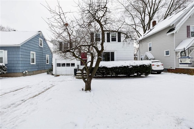 view of front of property featuring a garage and an outdoor structure