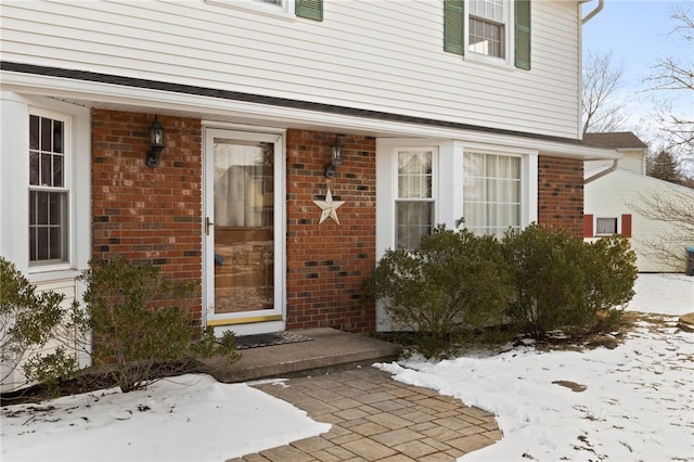 view of snow covered property entrance