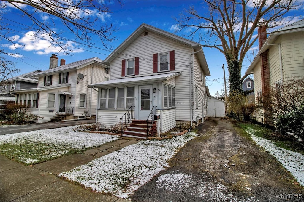 view of front of house featuring a sunroom