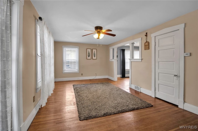 empty room with ceiling fan and light wood-type flooring