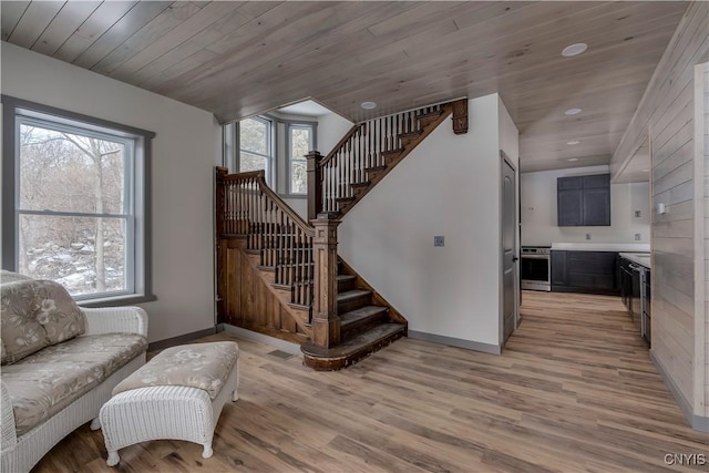 staircase featuring wood-type flooring and wooden ceiling