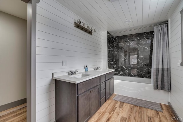 bathroom featuring shower / bath combo with shower curtain, vanity, and wood-type flooring