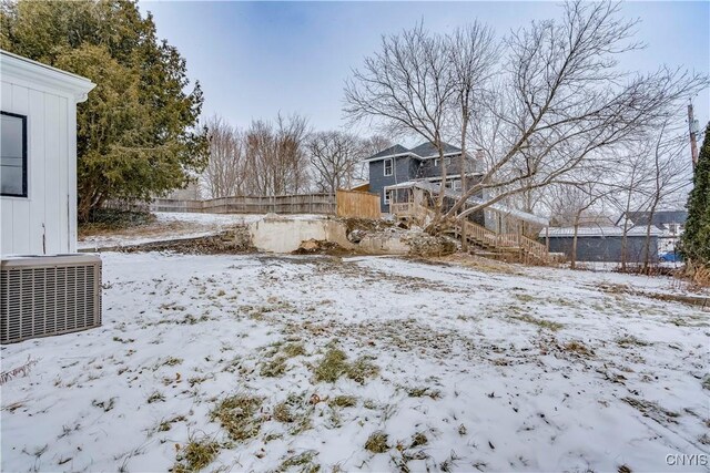 snowy yard featuring central AC