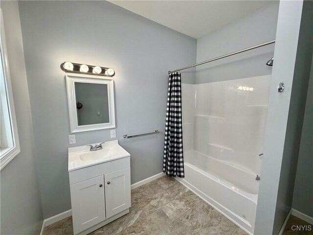 bathroom with shower / bathtub combination with curtain and vanity