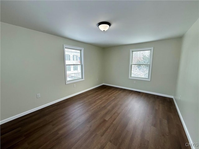 unfurnished room featuring dark hardwood / wood-style flooring