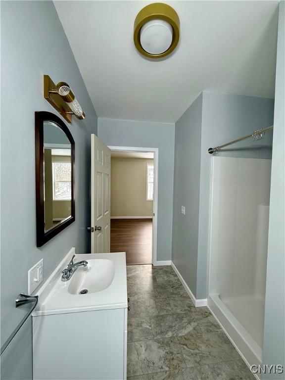 bathroom with vanity and walk in shower