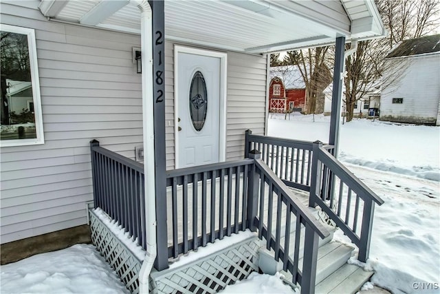 view of snow covered property entrance