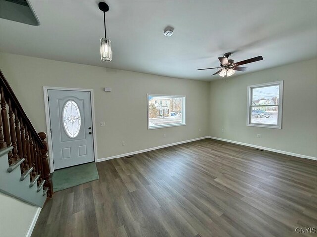 entrance foyer featuring dark hardwood / wood-style flooring, ceiling fan, and plenty of natural light