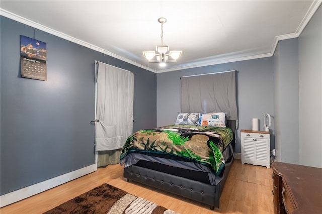 bedroom featuring hardwood / wood-style floors, an inviting chandelier, and crown molding