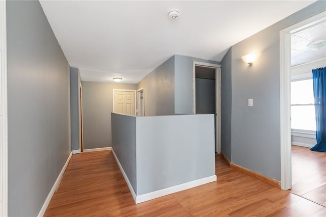 corridor with light hardwood / wood-style floors