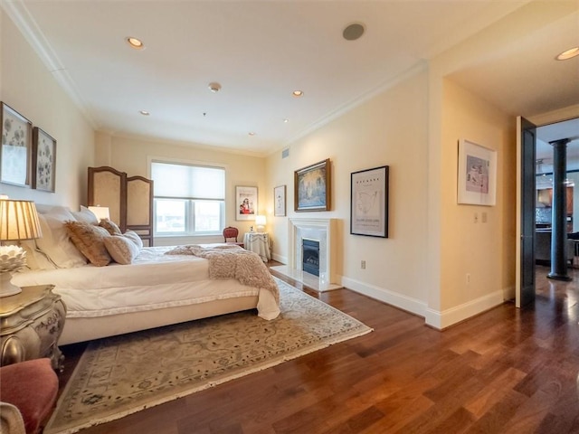 bedroom featuring ornamental molding and dark hardwood / wood-style flooring