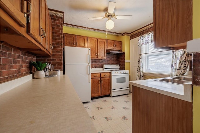 kitchen with sink, white appliances, and ceiling fan