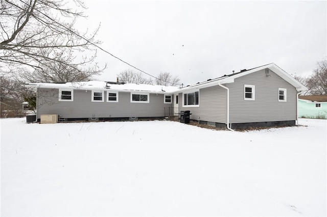 snow covered house with central AC