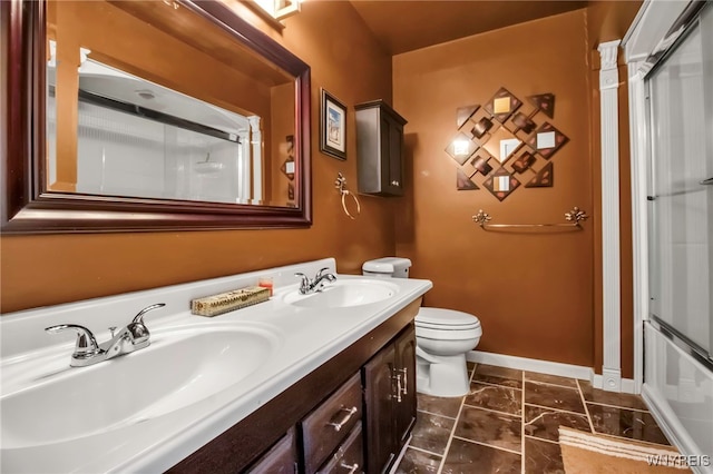 bathroom with toilet, walk in shower, and vanity