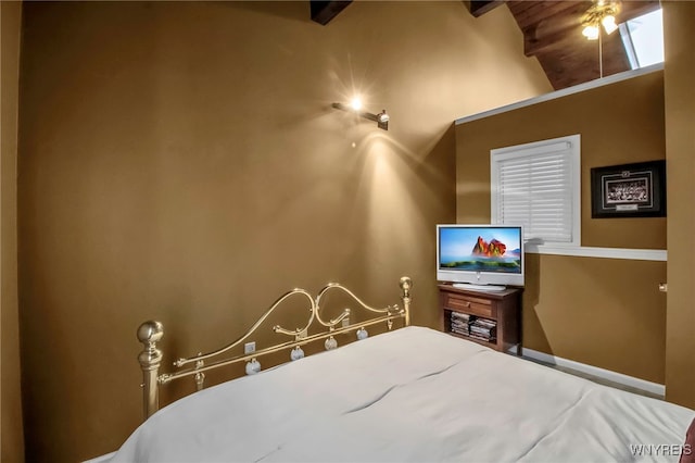 bedroom with vaulted ceiling with beams