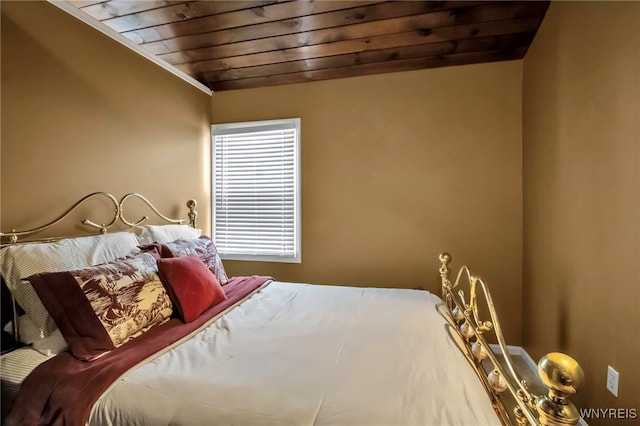 bedroom with wood ceiling and crown molding