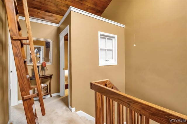 hall featuring ornamental molding, wood ceiling, lofted ceiling, and light colored carpet