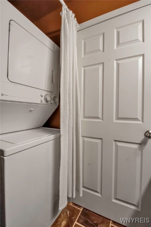 laundry area featuring stacked washer / dryer