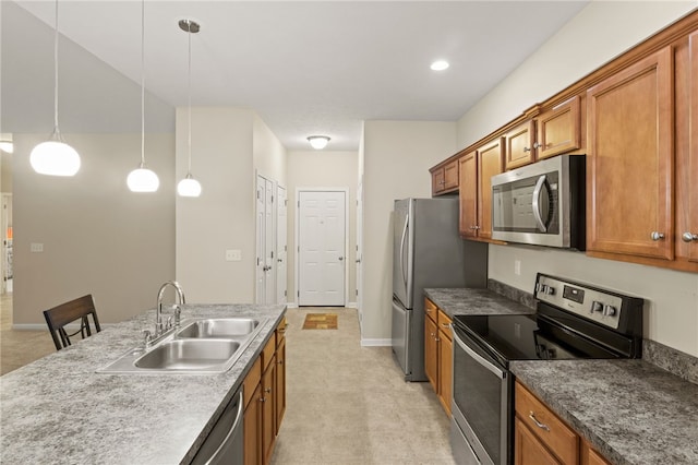 kitchen featuring sink, stainless steel appliances, a kitchen bar, and hanging light fixtures