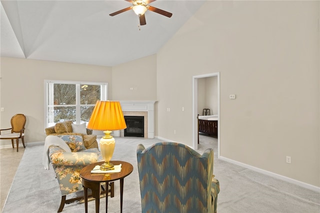 living room featuring high vaulted ceiling, a tiled fireplace, light carpet, and ceiling fan