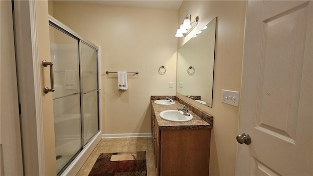 bathroom with a shower with door and vanity