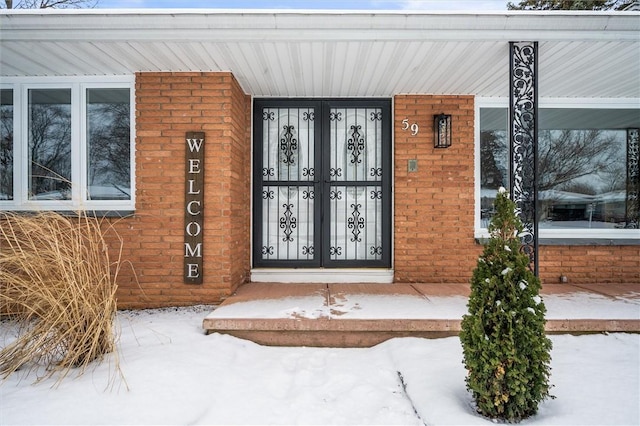 view of snow covered property entrance