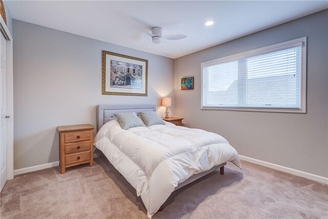 bedroom featuring ceiling fan and light colored carpet