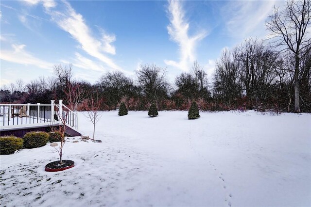 yard covered in snow featuring a wooden deck