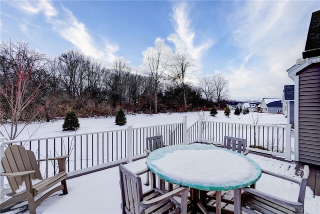 snow covered patio with a deck