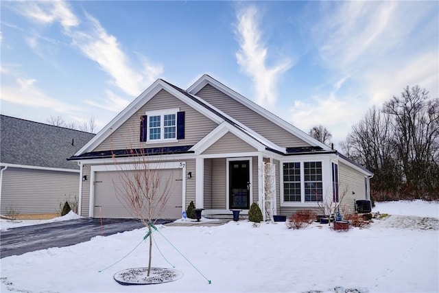 view of front of house featuring a garage and cooling unit