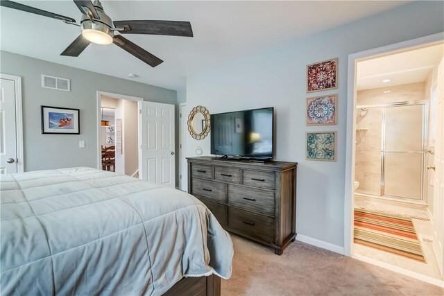 carpeted bedroom with ceiling fan and ensuite bath