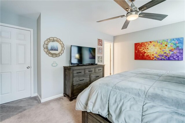 bedroom with ceiling fan and light carpet