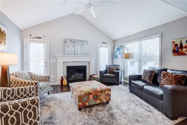 living room featuring ceiling fan, lofted ceiling, and hardwood / wood-style flooring