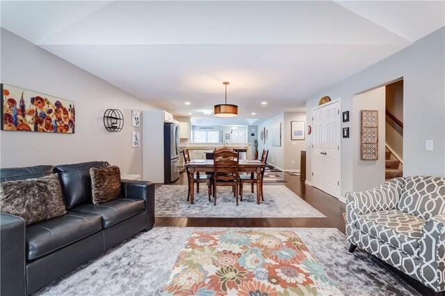 living room featuring hardwood / wood-style flooring and lofted ceiling