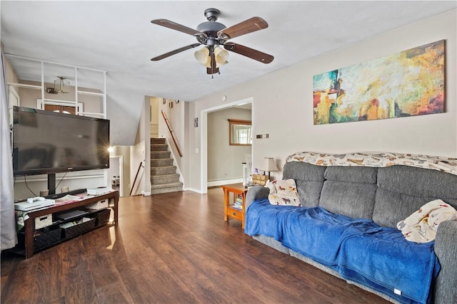 living room featuring a baseboard heating unit, ceiling fan, and dark hardwood / wood-style floors