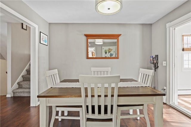 dining room with baseboard heating and dark wood-type flooring