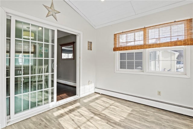 unfurnished sunroom with vaulted ceiling and a baseboard radiator