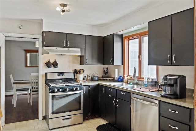 kitchen featuring sink, stainless steel appliances, and baseboard heating