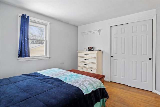 bedroom with a closet and light hardwood / wood-style floors