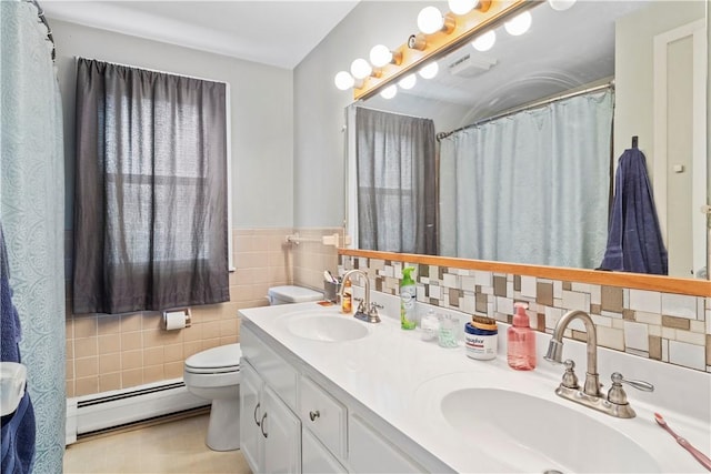 bathroom featuring vanity, tile walls, toilet, tile patterned floors, and a baseboard radiator