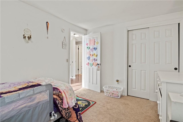 bedroom featuring a closet and light carpet