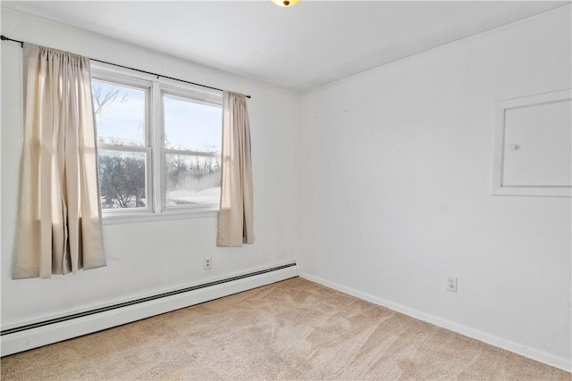 carpeted spare room featuring a baseboard heating unit