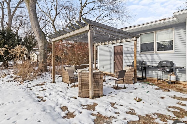 snow covered patio featuring grilling area