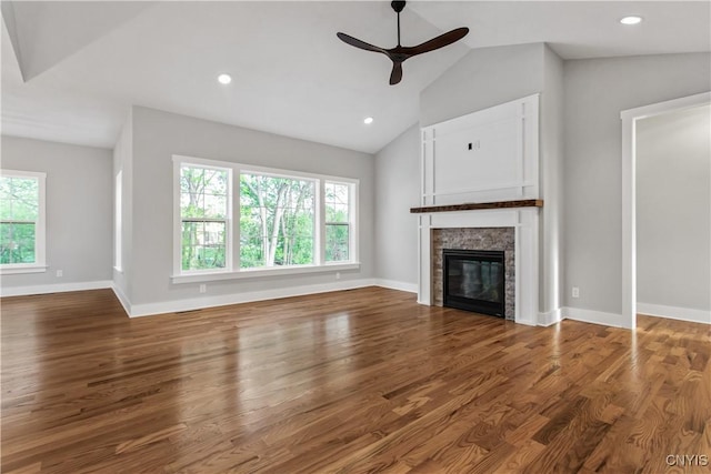 unfurnished living room with ceiling fan, hardwood / wood-style floors, and vaulted ceiling