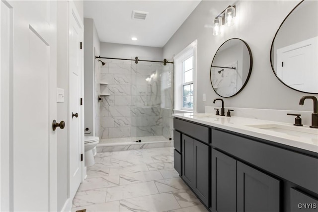 bathroom featuring toilet, tiled shower, and vanity