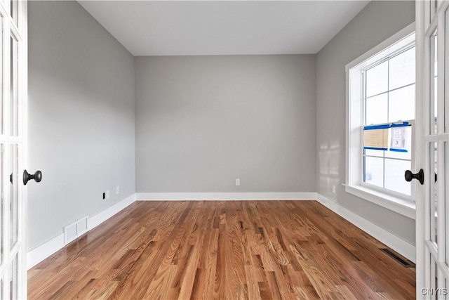 spare room with hardwood / wood-style floors