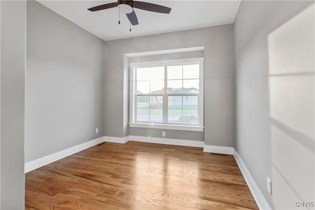 unfurnished room featuring ceiling fan and hardwood / wood-style floors